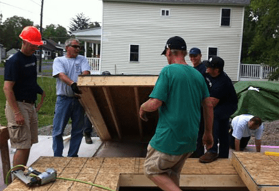 Volunteers help construct a Habitat for Humanity home.