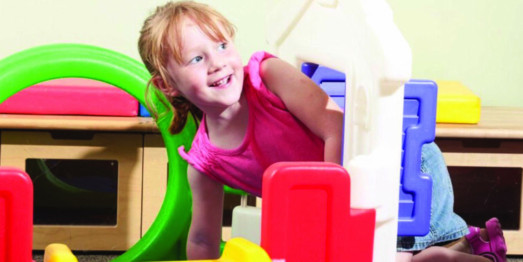 At Madison County CAP, a little girl is playing in the classroom.