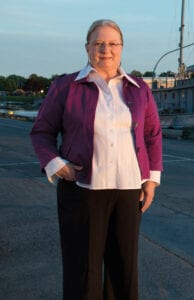 H. Lee White Maritime Museum director, Mercedes Niess, stands near the boat.