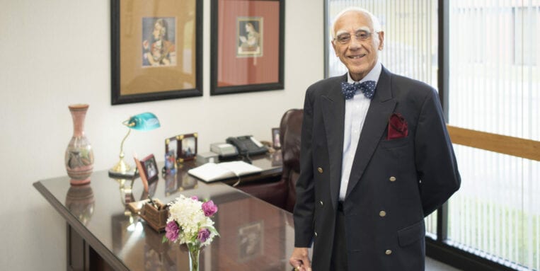 Mansukh Shah standing in his office