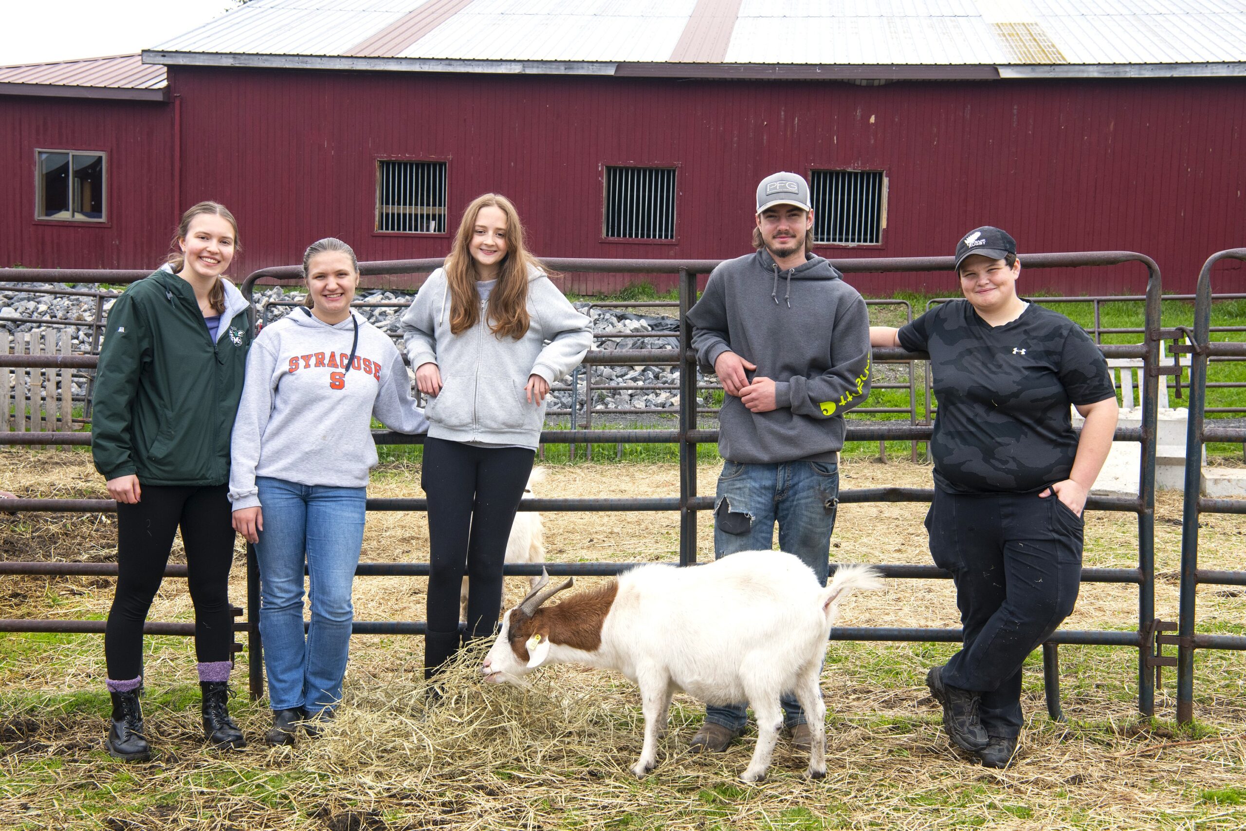Group of people standing with goat