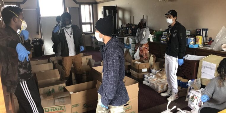 Northside Learning Center volunteers fill boxes of food