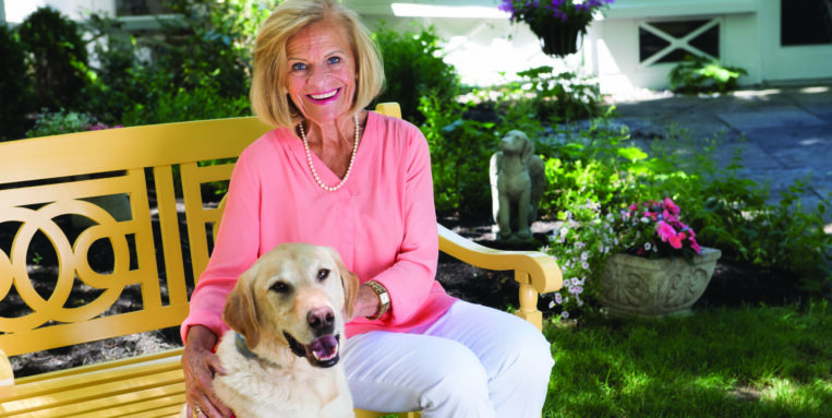 Mary Mathews poses with her dog