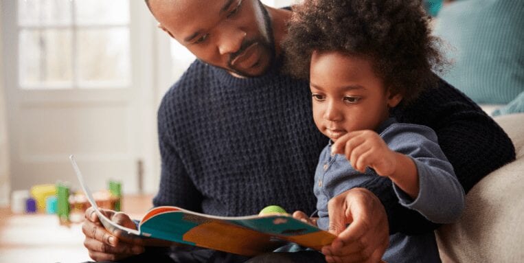 Man reading a book to a child