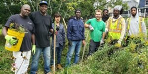 Men standing outside gardening
