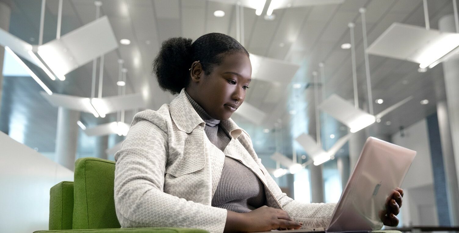 A Say Yes Scholar works on a laptop at Syracuse University