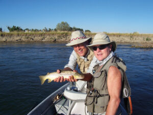 Two men holding fish