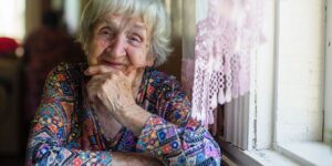 Older woman sits at a table