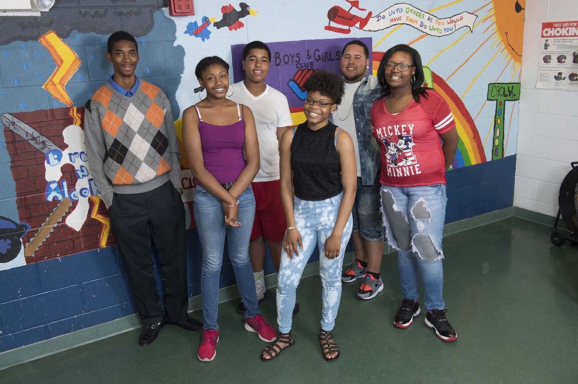 Six young people gather in front of mural at Boys & Girls Clubs