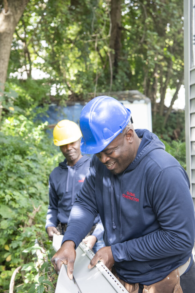 Two construction men smiling