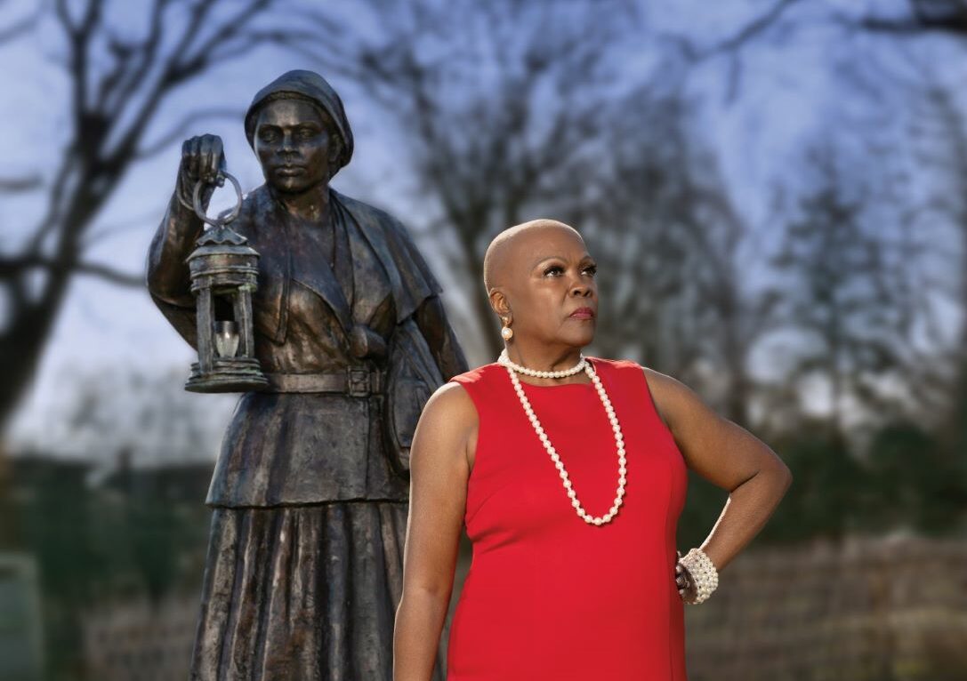 Woman standing in front of statue