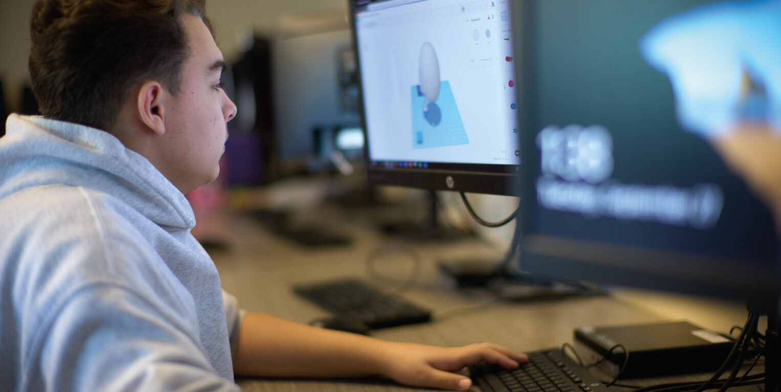 Boy sitting at computer