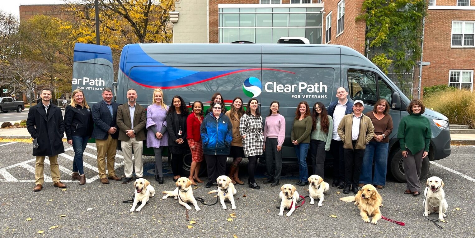 Group of people standing in front of a van