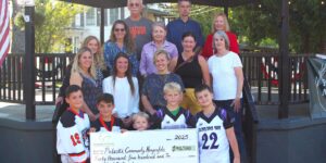 Group of people holding a check
