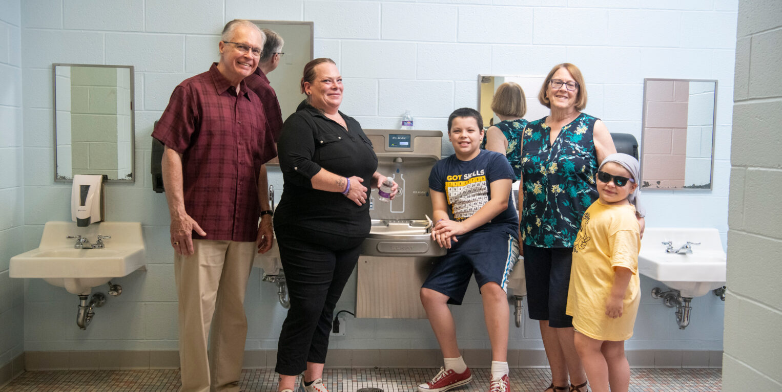 Group of People Standing In Front of Water Fountain