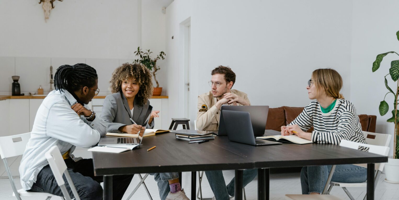 A group of people talking at a table
