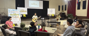 Young student performing to a small group of people