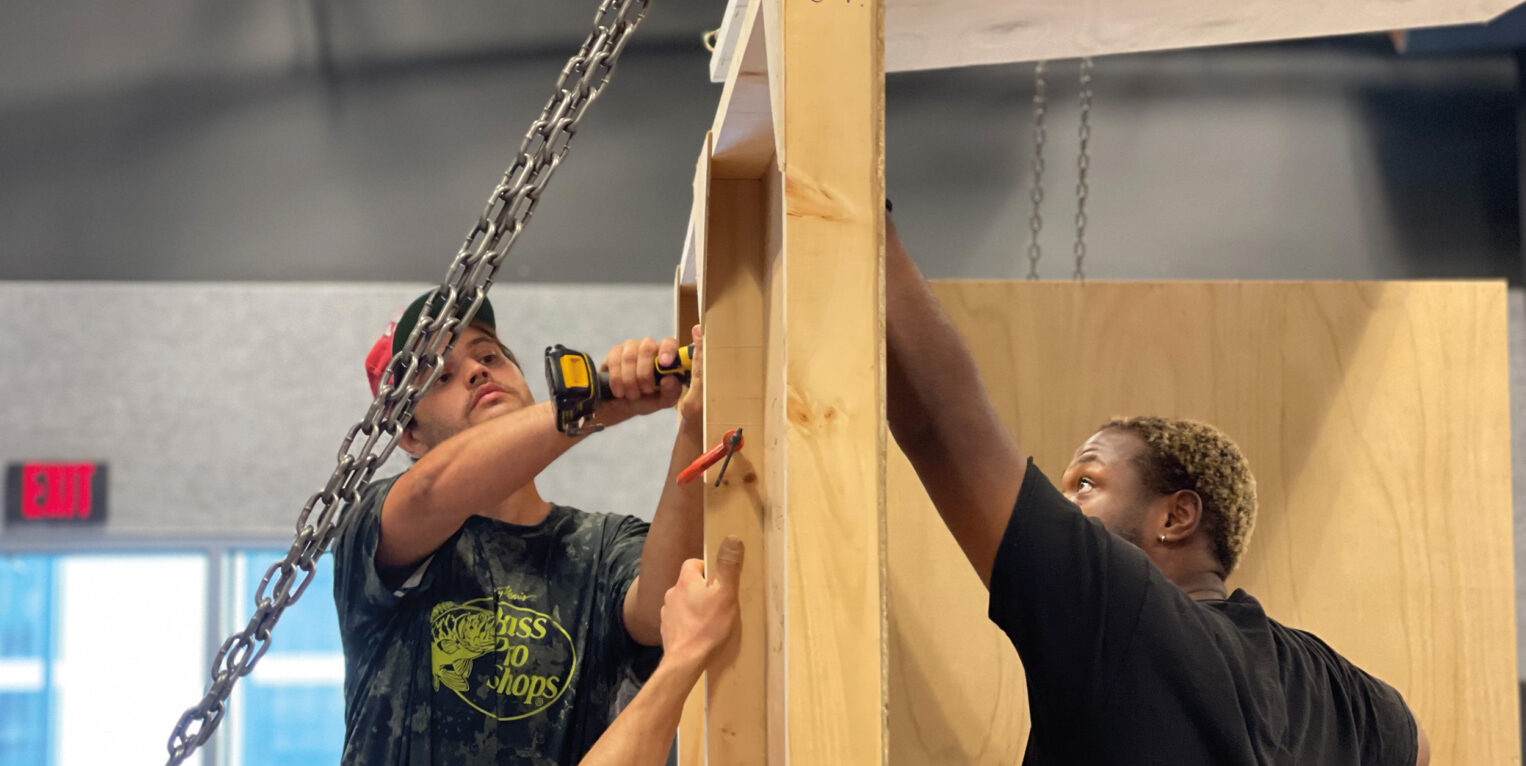 People doing work on a wall