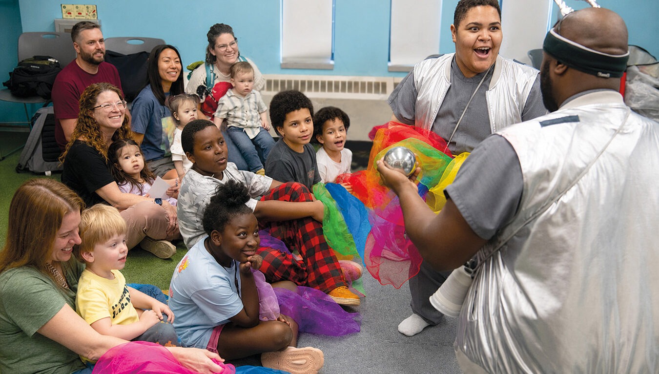 Group of kids sitting and watching a performance